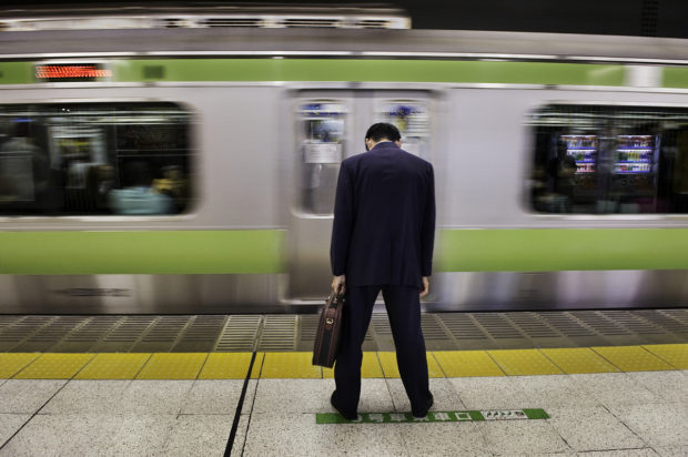 _SAM5672, British Airways, Tokyo, Japan, 2008, JAPAN-10026. A man waits for his train. PORTRAITS_APP final print_UrbanArt'12 retouch_Sonny Fabbri